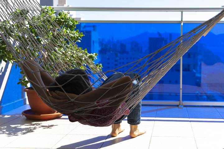 A hammock is one of the best cozy balcony ideas.
